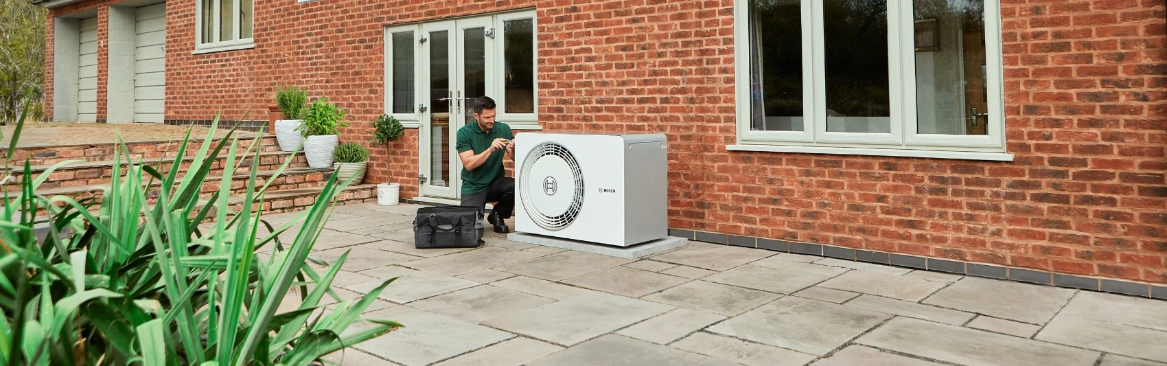 Installer in front of heat pump