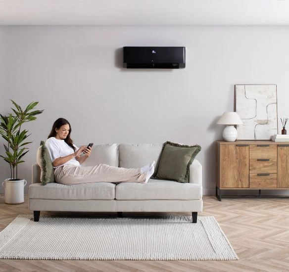 woman in lounge with climate 7000i unit on the wall