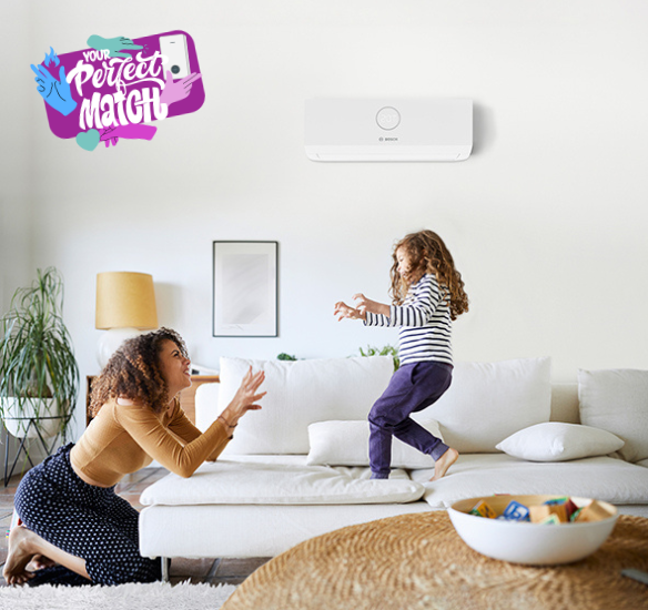 mother and daughter playing with air conditioning unit on the wall