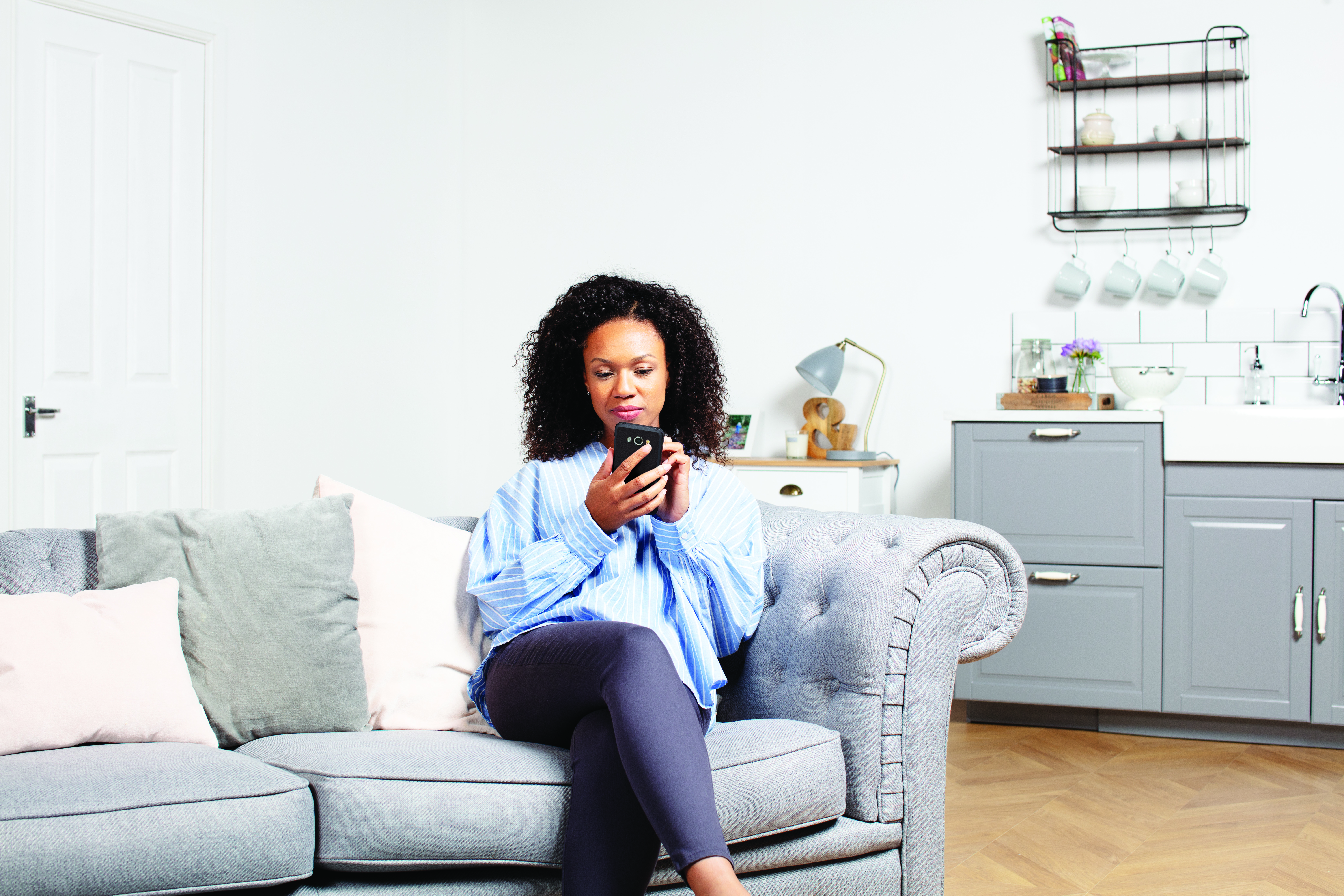 Woman checking as bills on phone