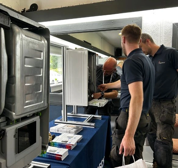 Installers speaking to an engineer about boilers