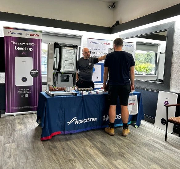Installers at the Solihull roadshow speaking to a boiler engineer