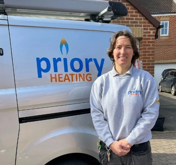 Liza standing in front of Priory Heating van