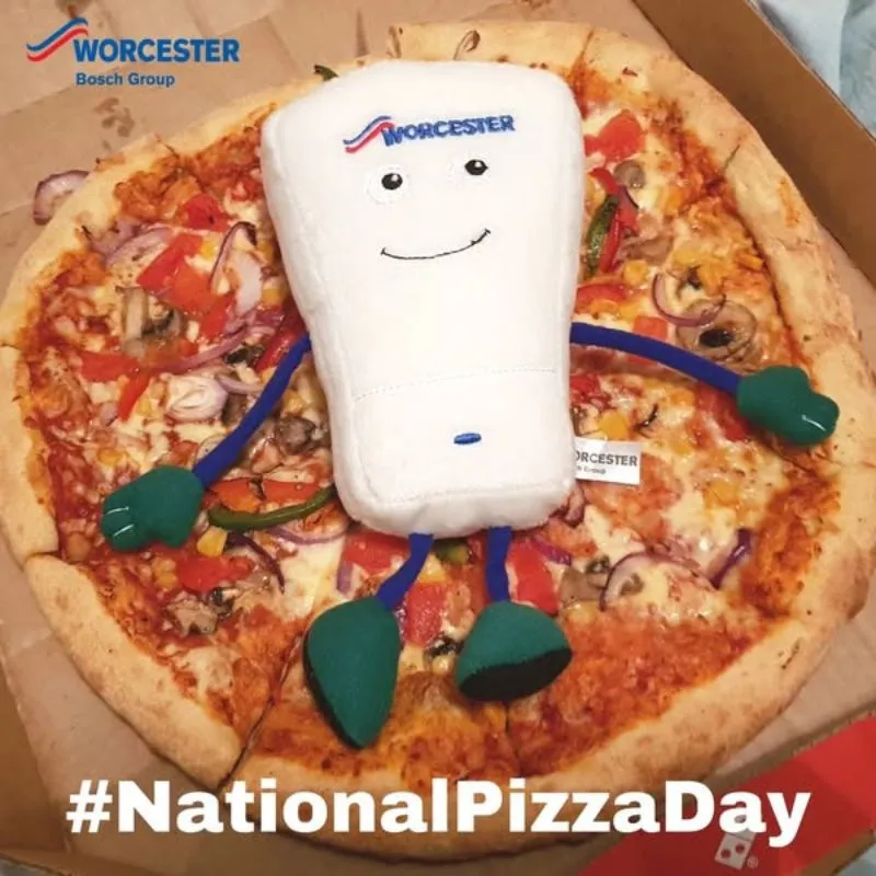 Bobby plush on top of pizza for National Pizza Day
