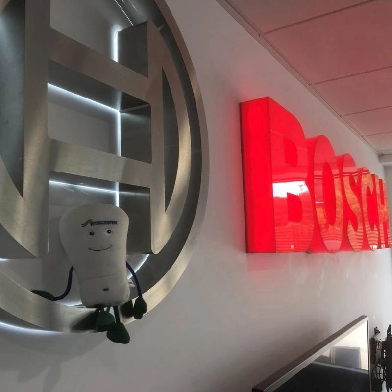 Bobby sat in front of Bosch sign