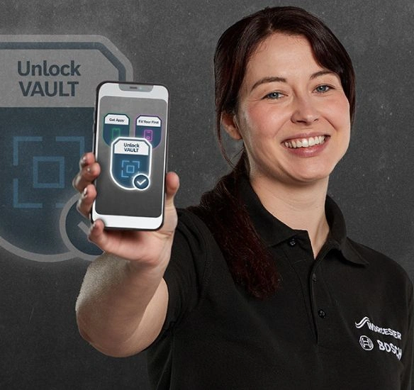 Female installer holding phone with Challenge Board badges