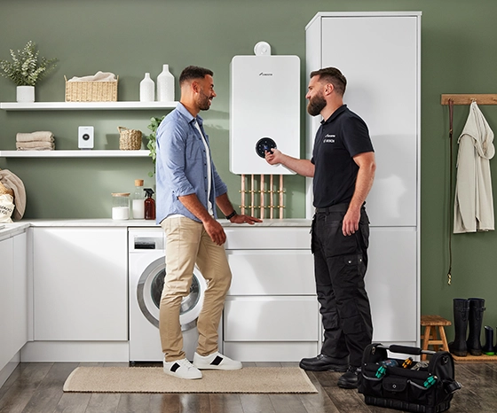 installer and homeowner discussing Greenstar 8000 plus boiler in kitchen