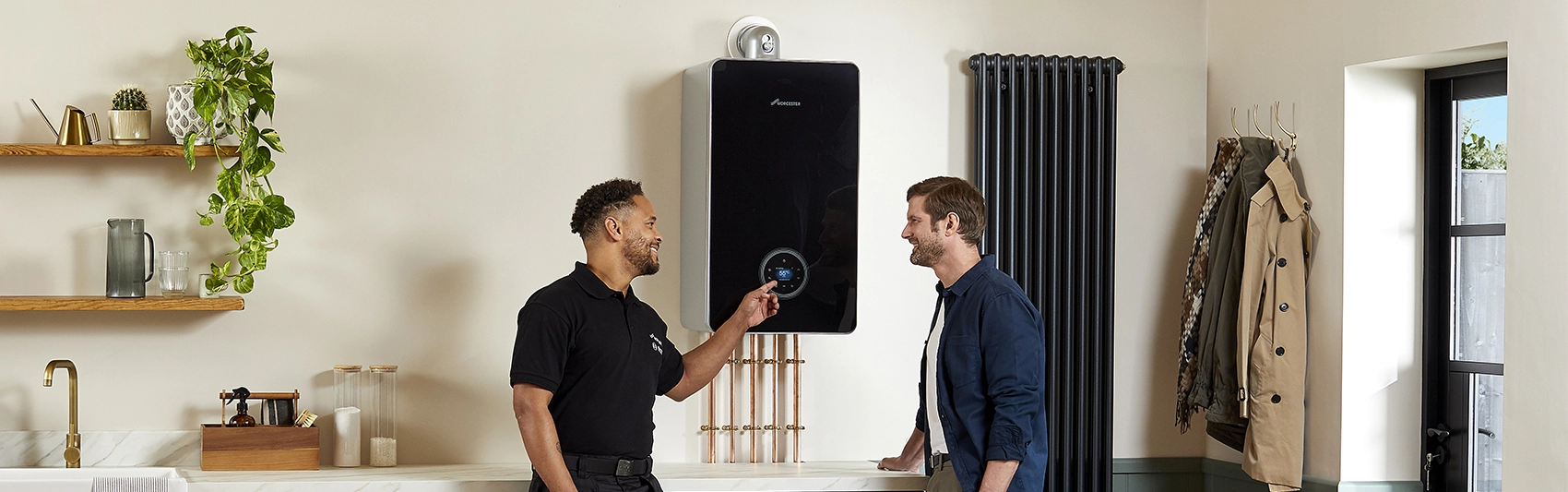 A homeowner with an installer explaining his new boiler